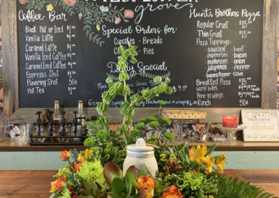 Vases with flowers and floristry tools on wooden table